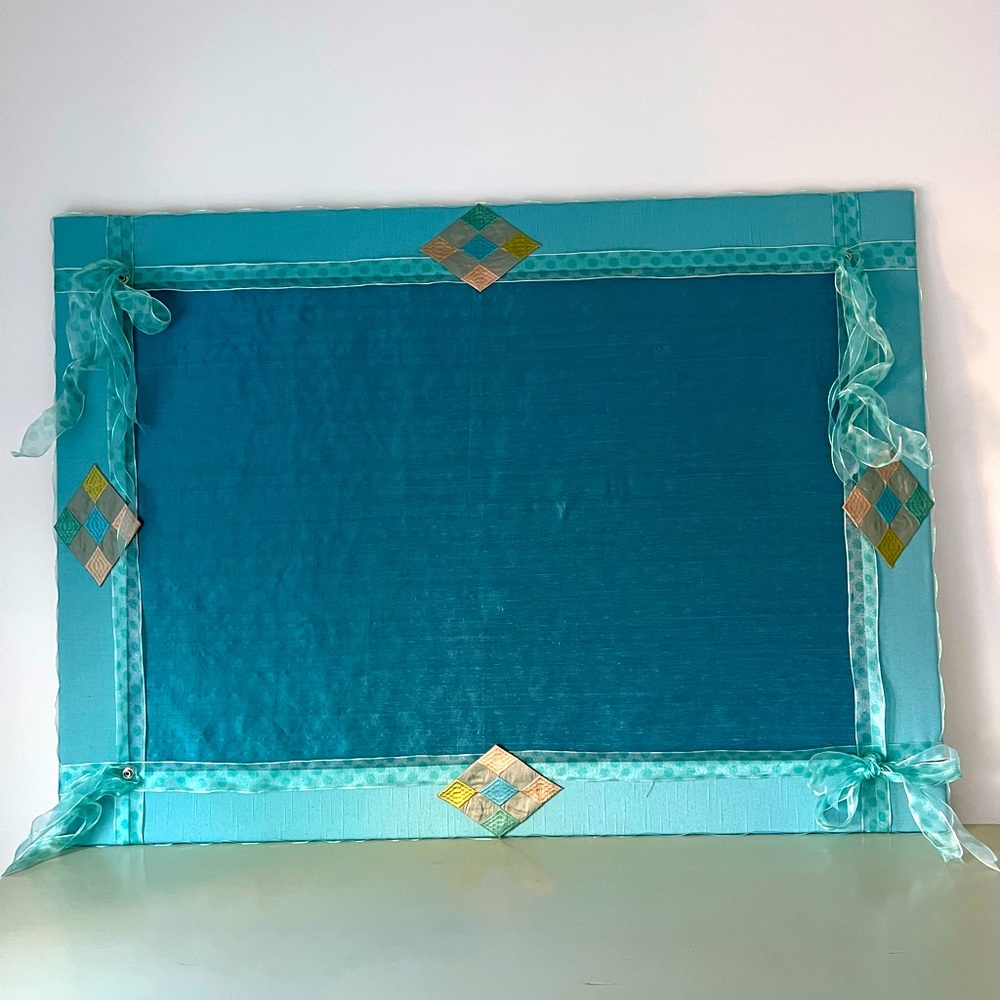 Large bulletin board custom-made in find fabric.